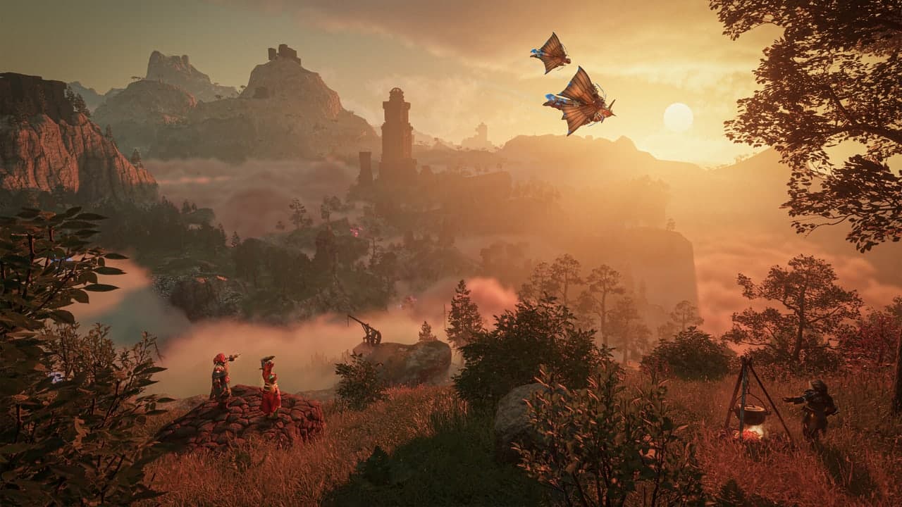 Adventurers overlook a misty valley at sunset in Enshrouded.