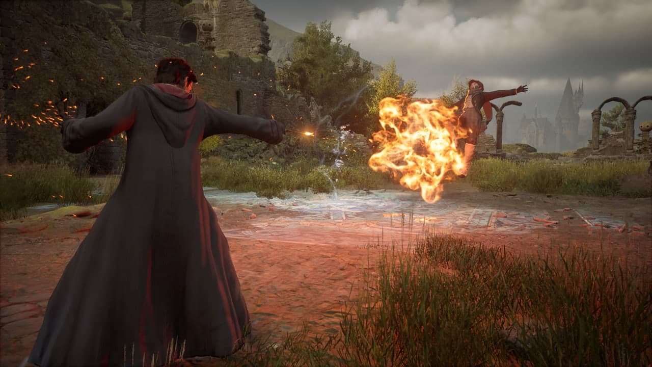 A Hogwarts Legacy student casts a fiery spell during an outdoor fight.