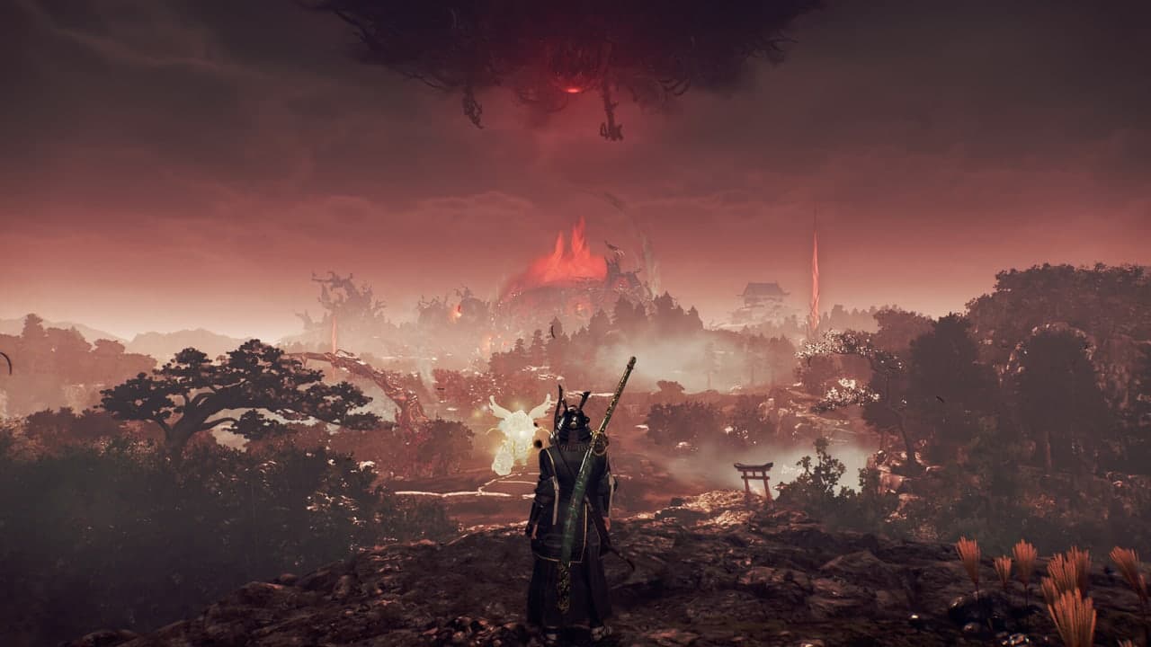 A warrior overlooks a burning red landscape in Nioh 3.